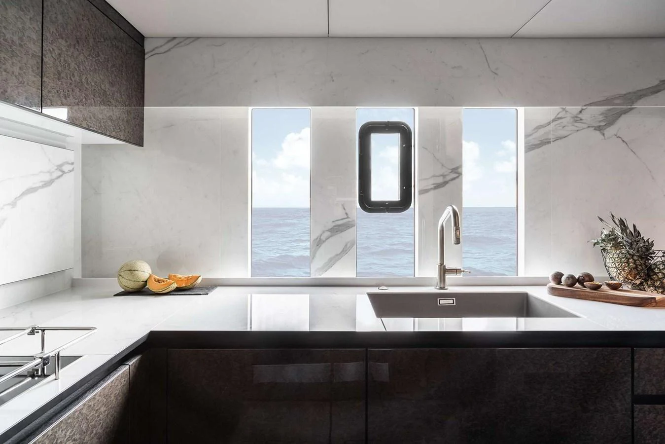 The galley features sleek countertops, modern fixtures, and a picturesque ocean view through the windows. aboard 80 SUNREEF POWER NEXT Yacht for Sale