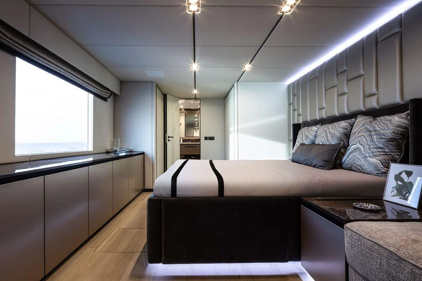 A luxurious stateroom featuring a large bed, modern decor, and ample natural light. aboard 80 SUNREEF POWER NEXT Yacht for Sale