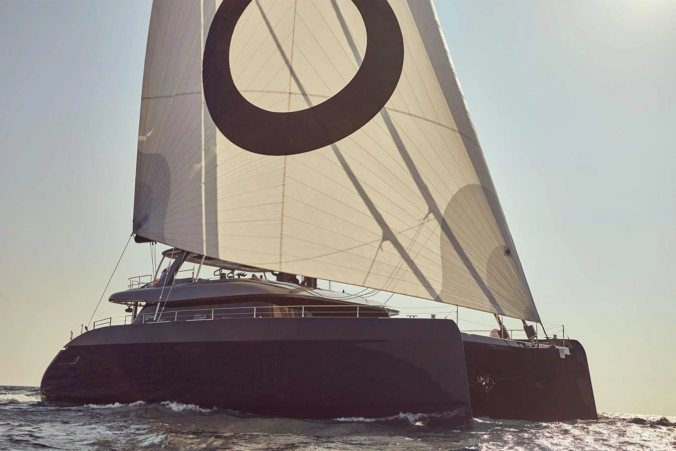 A sleek and modern sailing yacht glides effortlessly on the water, showcasing its impressive sail and elegant design. aboard SUNREEF 80 NEXT Yacht for Sale