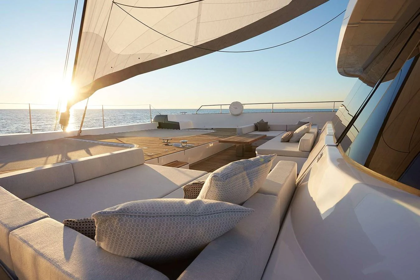 The sundeck offers luxurious lounging with expansive views of the sea at sunset. aboard SUNREEF 80 NEXT Yacht for Sale