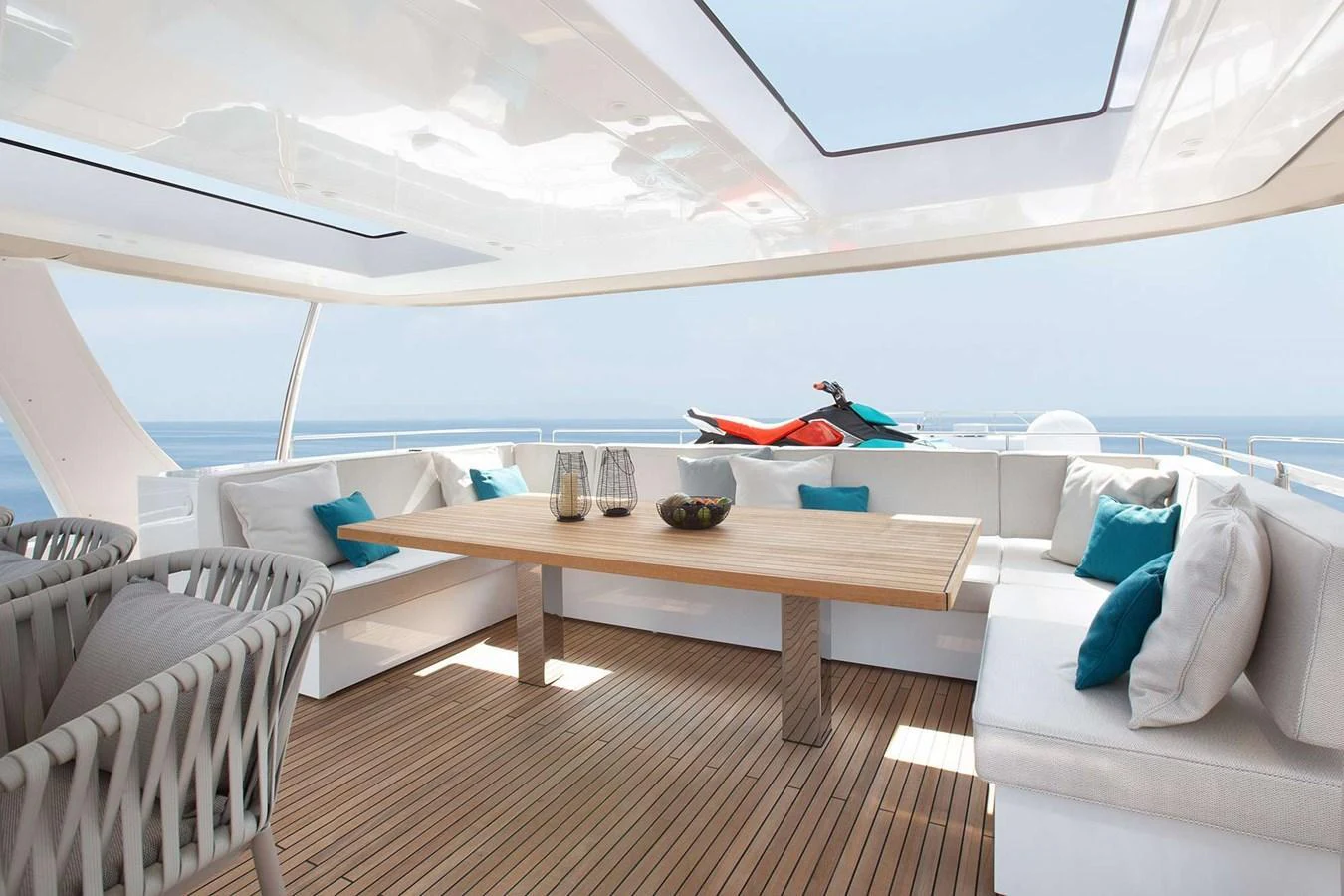 The sundeck offers a spacious seating area with a large dining table and stunning ocean views. aboard SUNREEF 80 NEXT Yacht for Sale