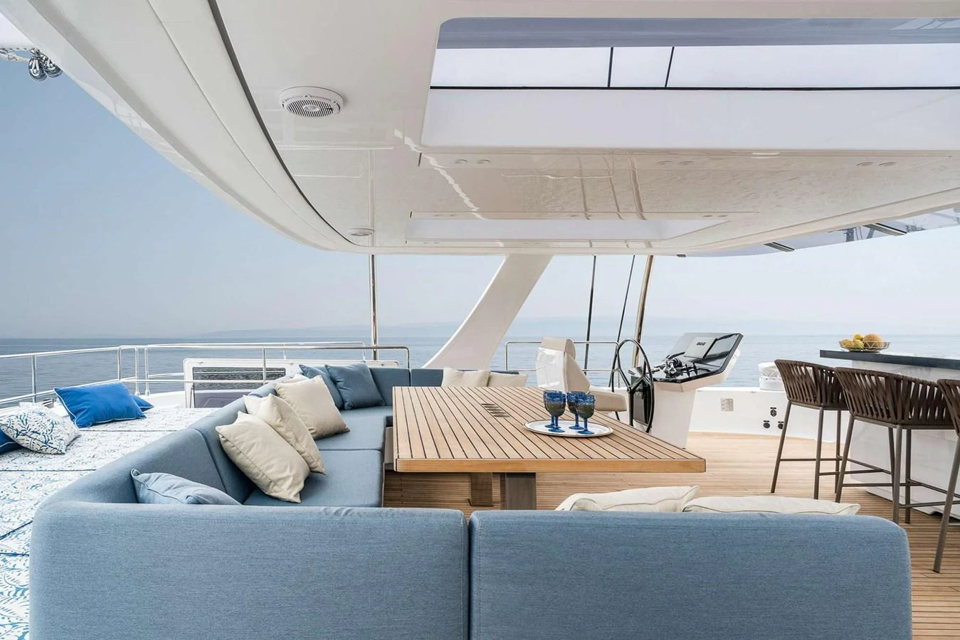 The flybridge offers a spacious seating area with a large table, perfect for outdoor dining and relaxation. aboard SUNREEF 80 NEXT Yacht for Sale