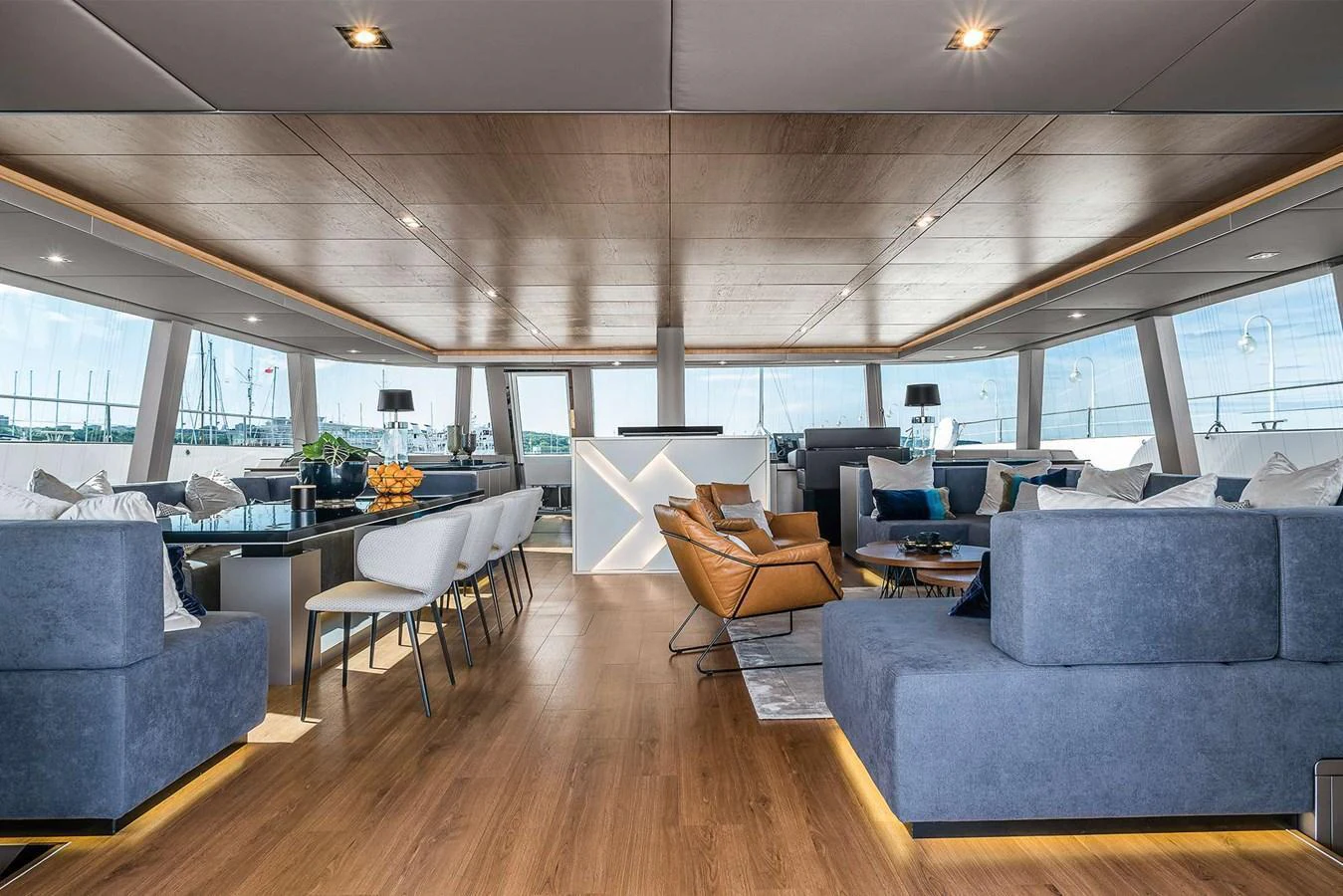 The spacious salon features modern furnishings and panoramic windows for a luxurious onboard experience. aboard SUNREEF 80 NEXT Yacht for Sale