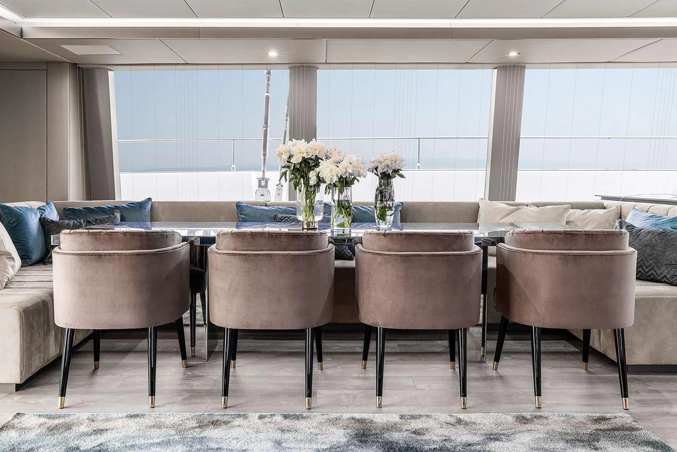 The yacht's dining area features elegant seating and a panoramic view. aboard SUNREEF 80 NEXT Yacht for Sale