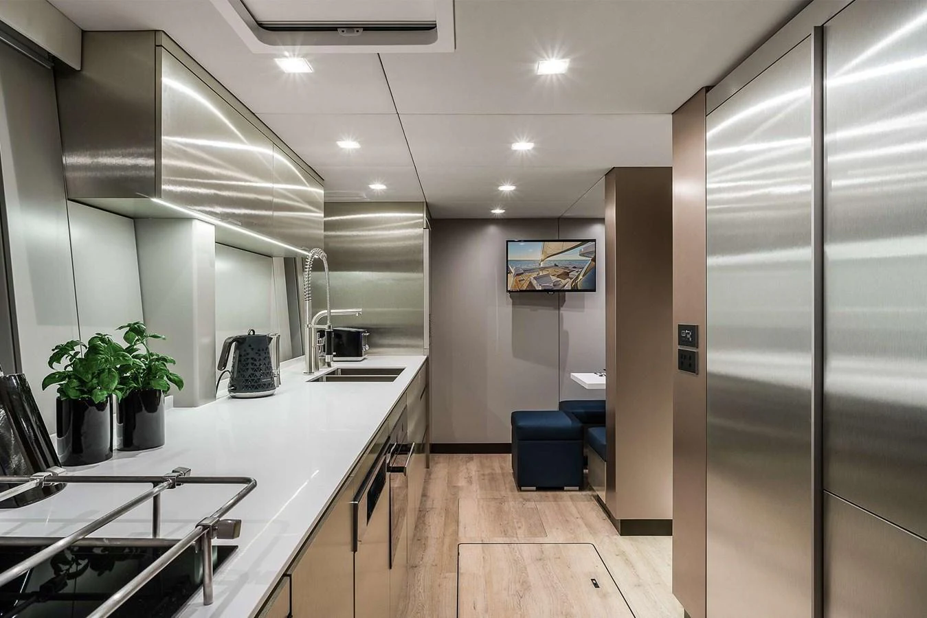 The sleek and modern galley features stainless steel appliances and ample counter space. aboard SUNREEF 80 NEXT Yacht for Sale