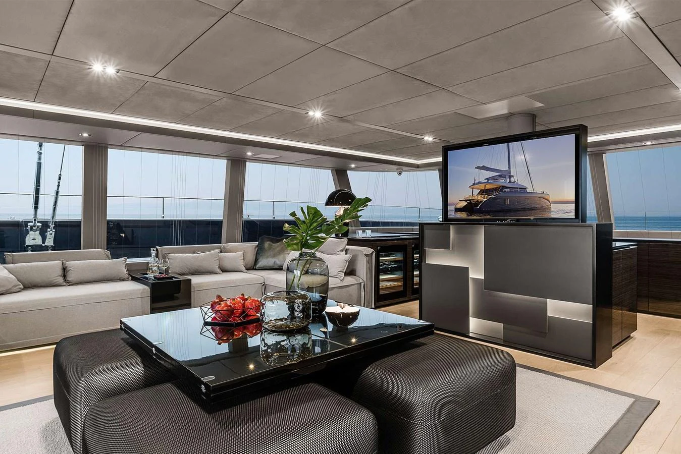 The salon offers a luxurious and modern space with ample seating and a large TV for entertainment. aboard SUNREEF 80 NEXT Yacht for Sale