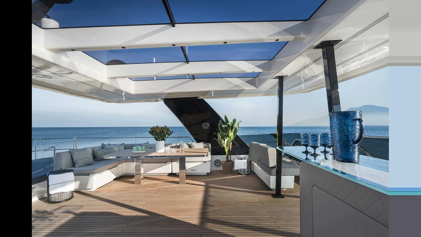 The aft deck features a spacious lounging area with modern furnishings and a bar, offering stunning ocean views. aboard 70 SUNREEF POWER NEXT Yacht for Sale