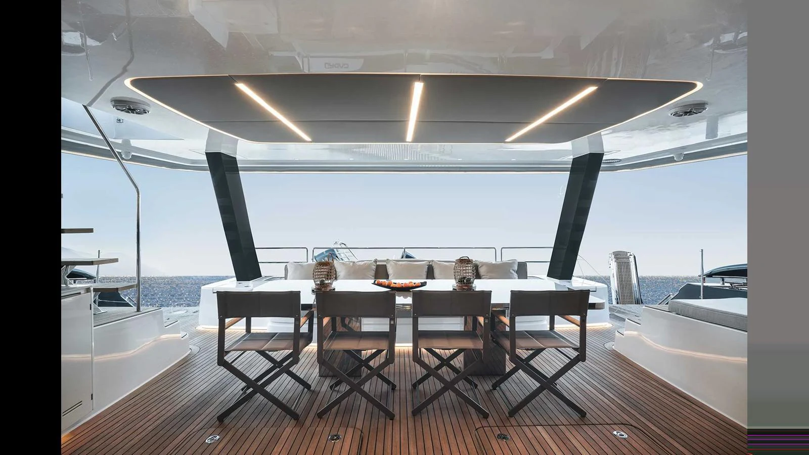 The aft deck features a stylish dining area with a stunning ocean view. aboard 70 SUNREEF POWER NEXT Yacht for Sale