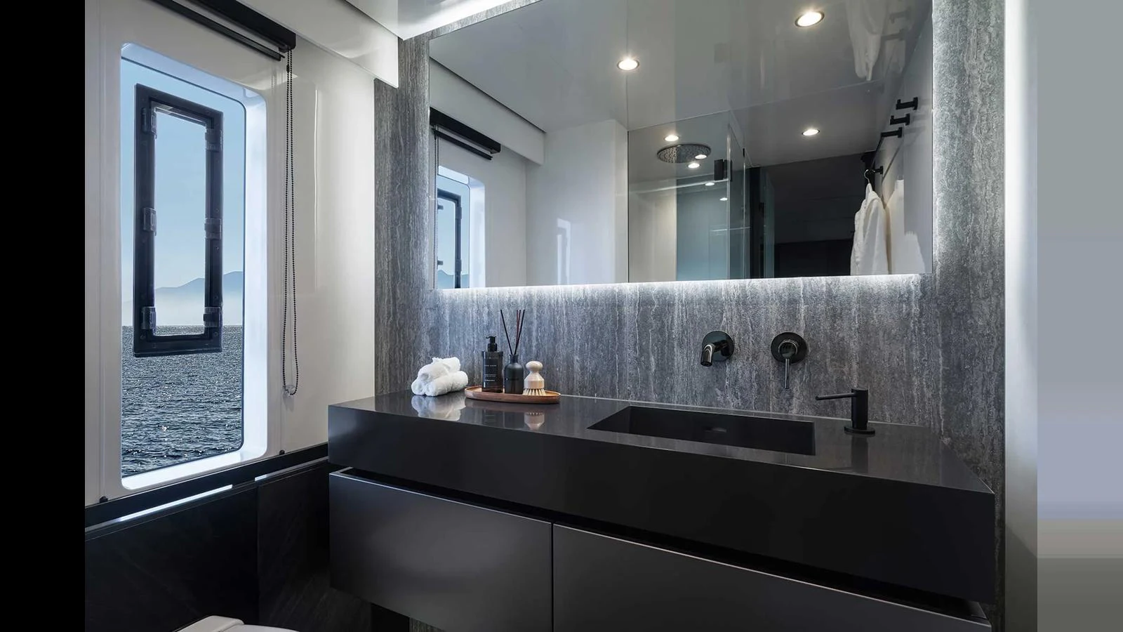 A sleek and modern yacht bathroom with a large mirror and stylish fixtures. aboard 70 SUNREEF POWER NEXT Yacht for Sale