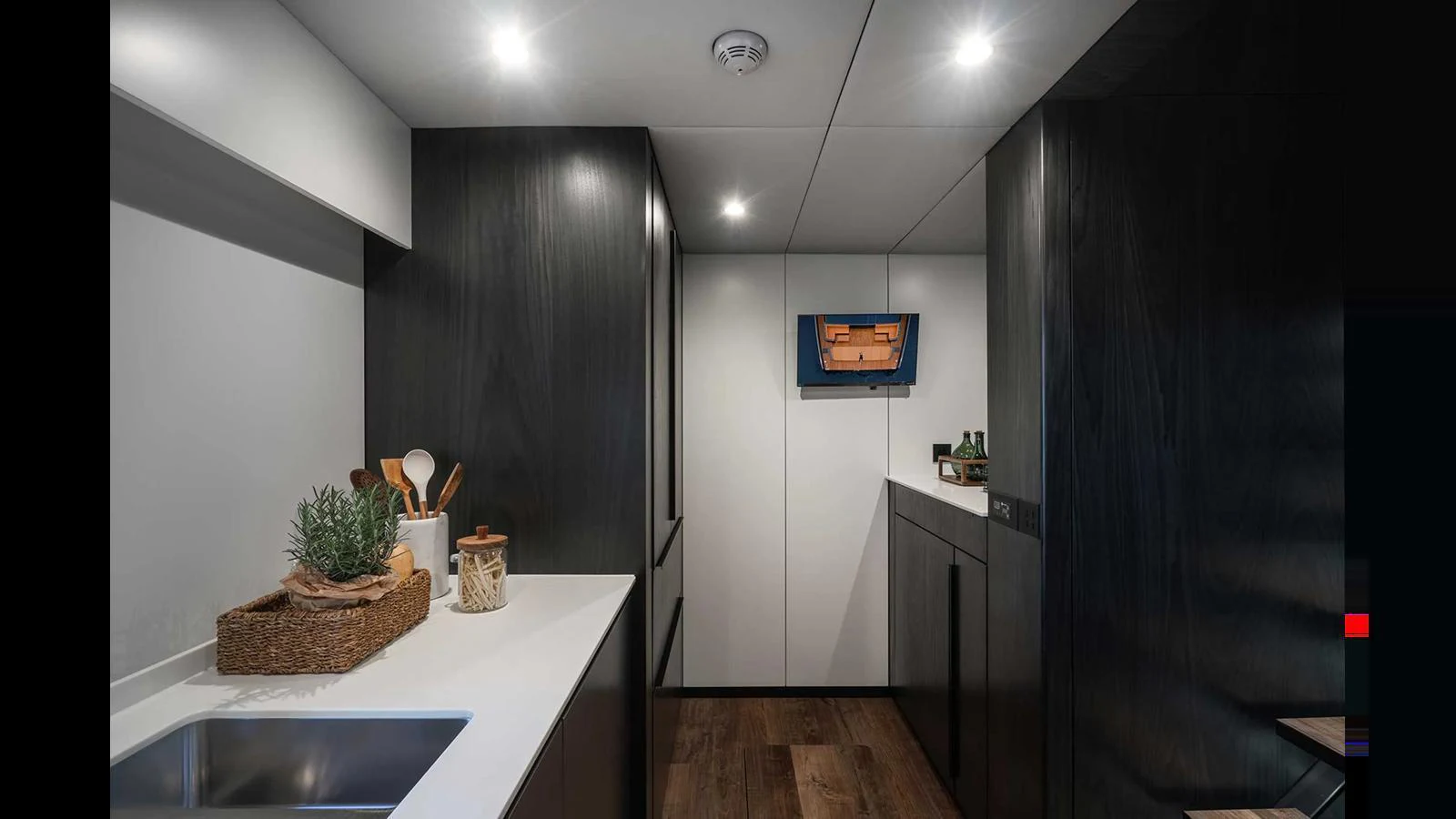 A sleek and modern galley with dark cabinetry and stylish decor. aboard 70 SUNREEF POWER NEXT Yacht for Sale