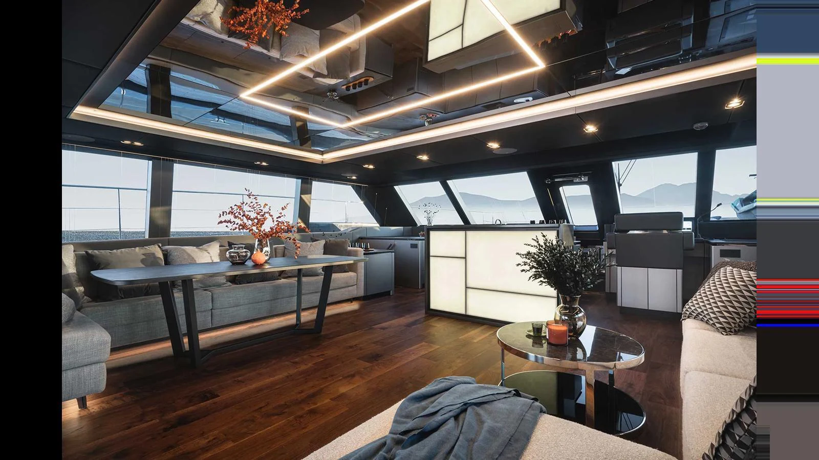 The salon features modern furnishings with ample seating and a sleek, illuminated bar area. aboard 70 SUNREEF POWER NEXT Yacht for Sale