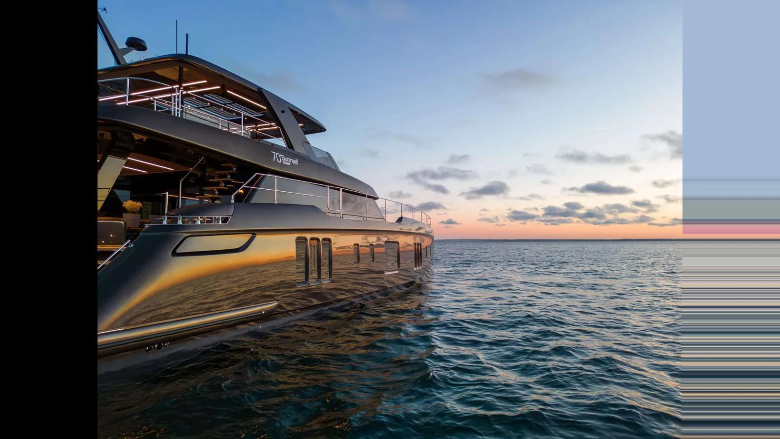 A sleek yacht glides through calm waters at sunset, showcasing its modern design and luxurious amenities. aboard 70 SUNREEF POWER NEXT Yacht for Sale
