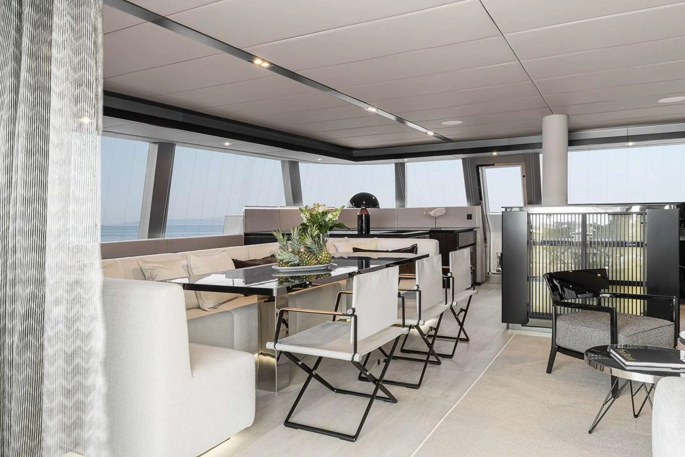 The yacht's salon features modern furnishings and expansive windows, creating a bright and inviting space. aboard SUNREEF 70 NEXT Yacht for Sale