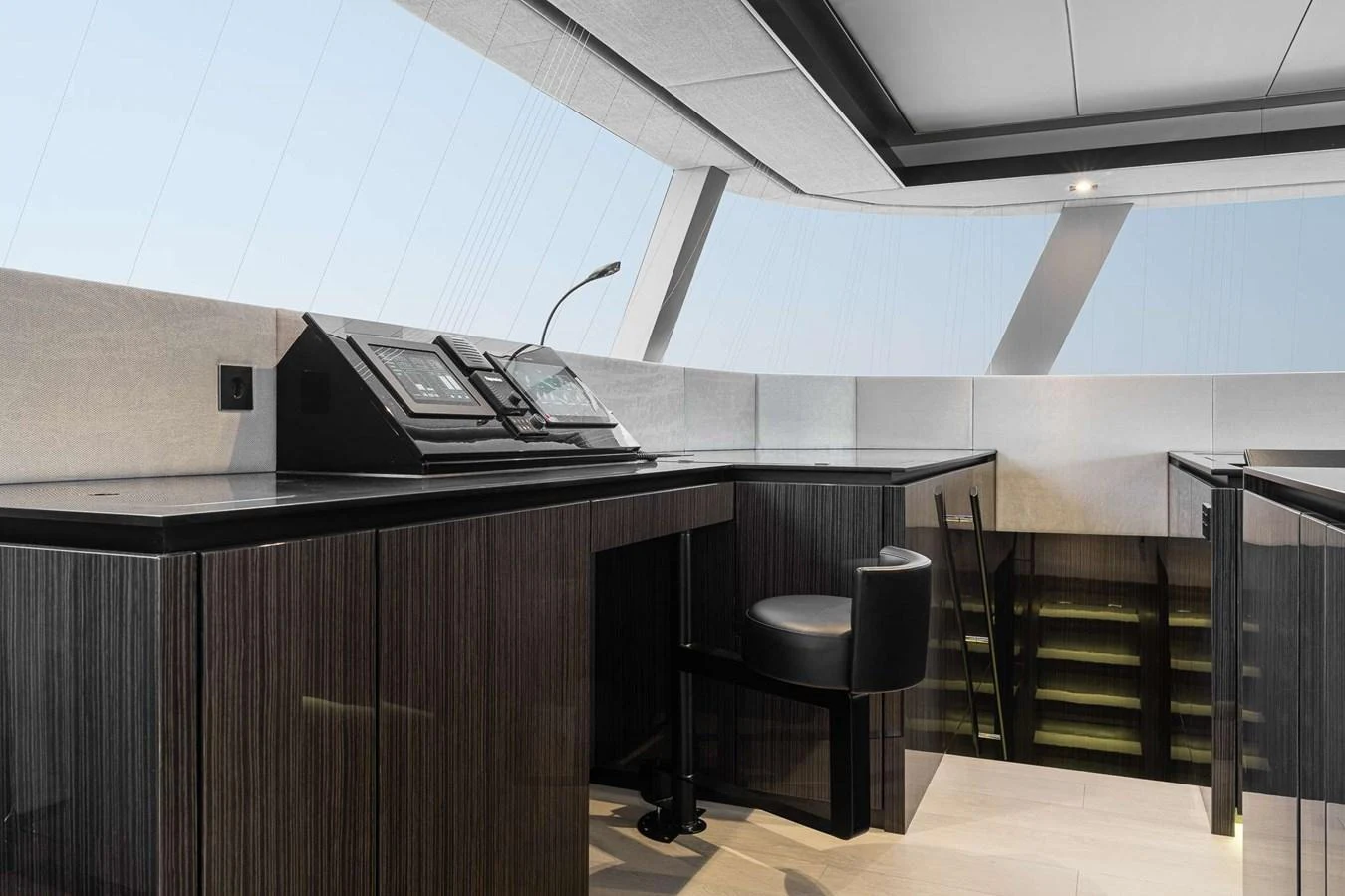The helm station features sleek, modern design with advanced navigation equipment and a comfortable seating area. aboard SUNREEF 70 NEXT Yacht for Sale