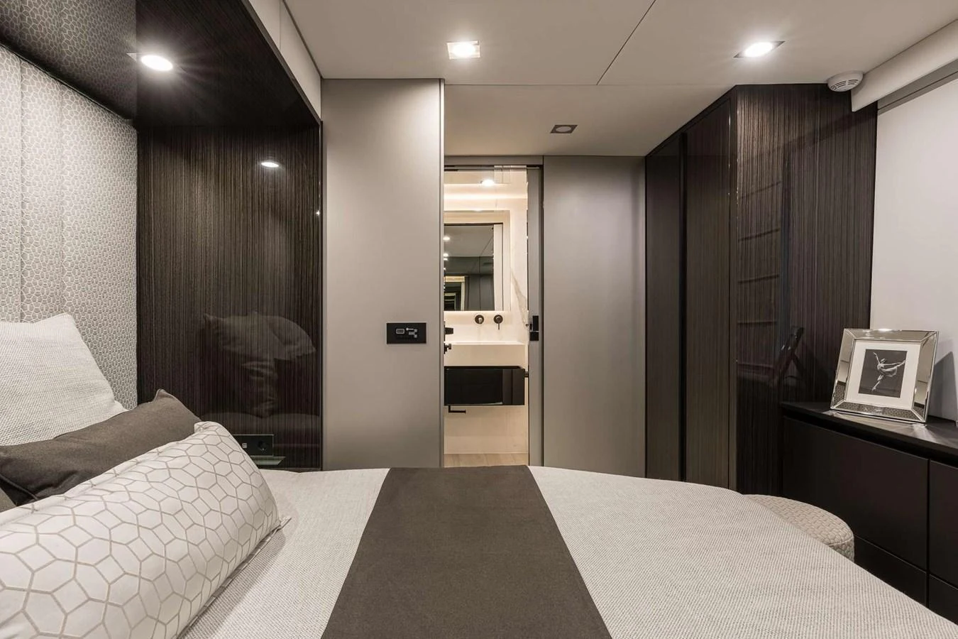 The stateroom features a modern design with a comfortable bed and sleek furnishings. aboard SUNREEF 70 NEXT Yacht for Sale