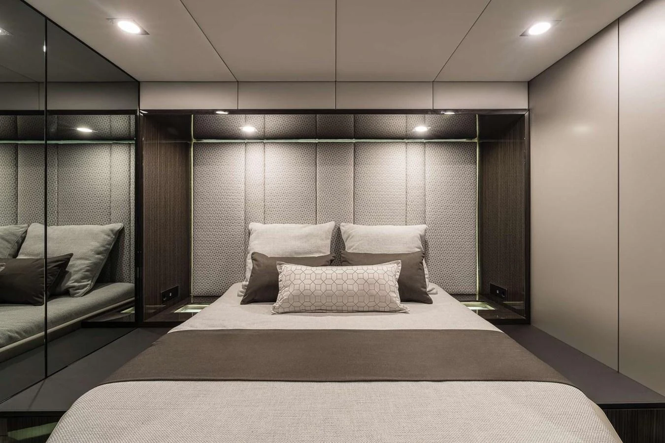 The stateroom features a plush bed with elegant bedding and mirrored walls, creating a spacious and luxurious atmosphere. aboard SUNREEF 70 NEXT Yacht for Sale