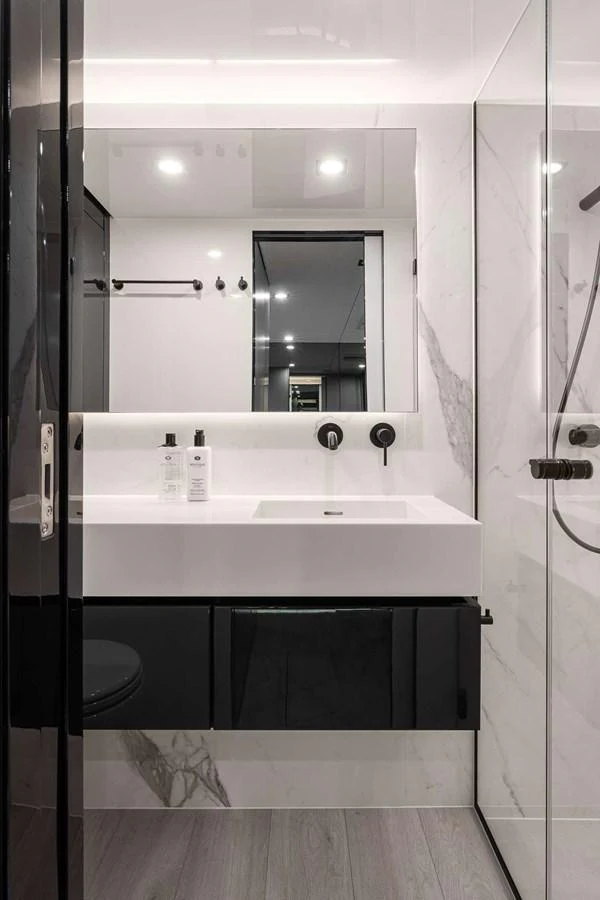 A sleek and modern yacht bathroom featuring a minimalist design with high-end fixtures. aboard SUNREEF 70 NEXT Yacht for Sale