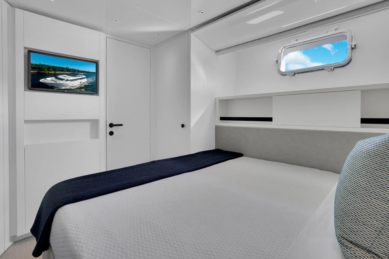 a bed with a television on the wall aboard SWEET VIRGINIA Yacht for Sale