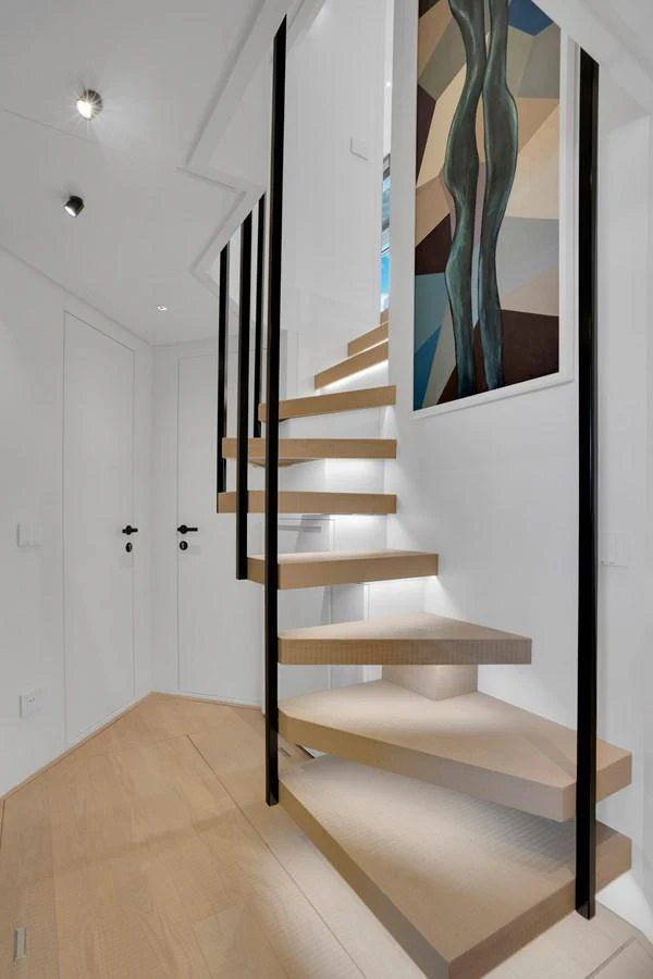 a staircase with a painting on the wall aboard SWEET VIRGINIA Yacht for Sale