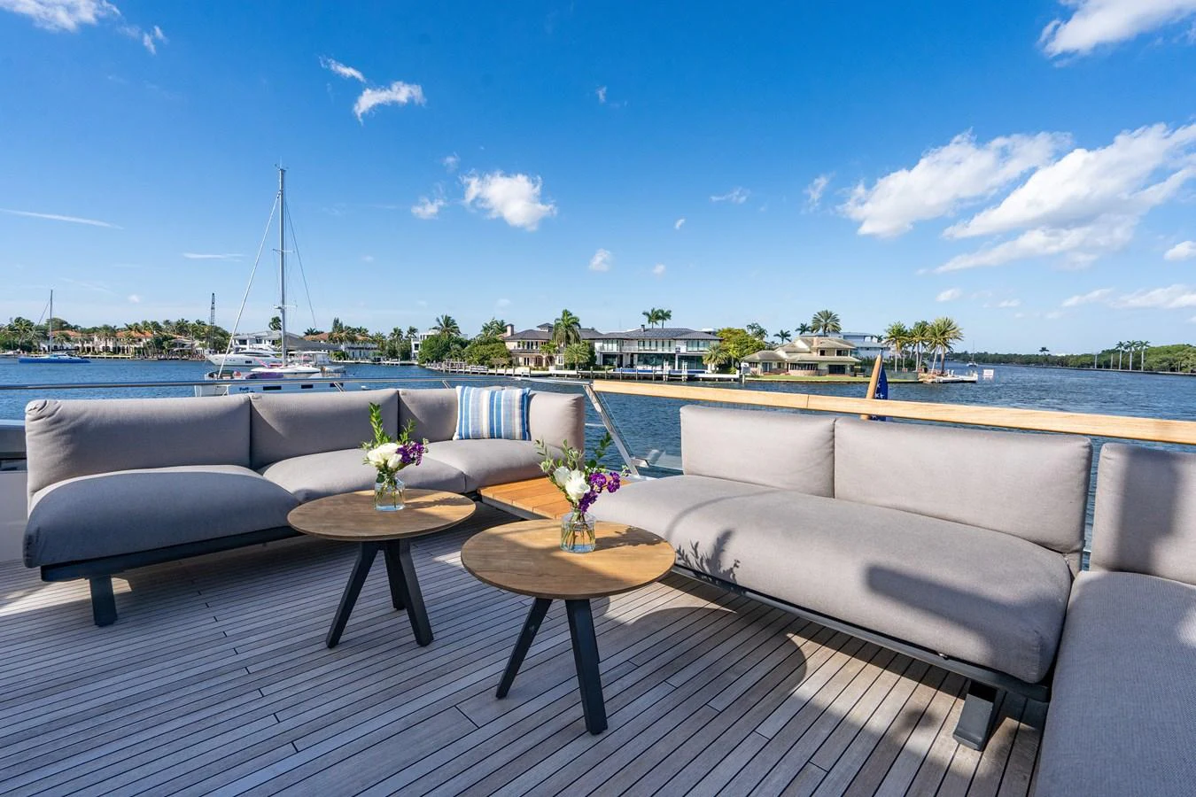 a group of couches on a deck overlooking a body of water aboard SWEET VIRGINIA Yacht for Sale