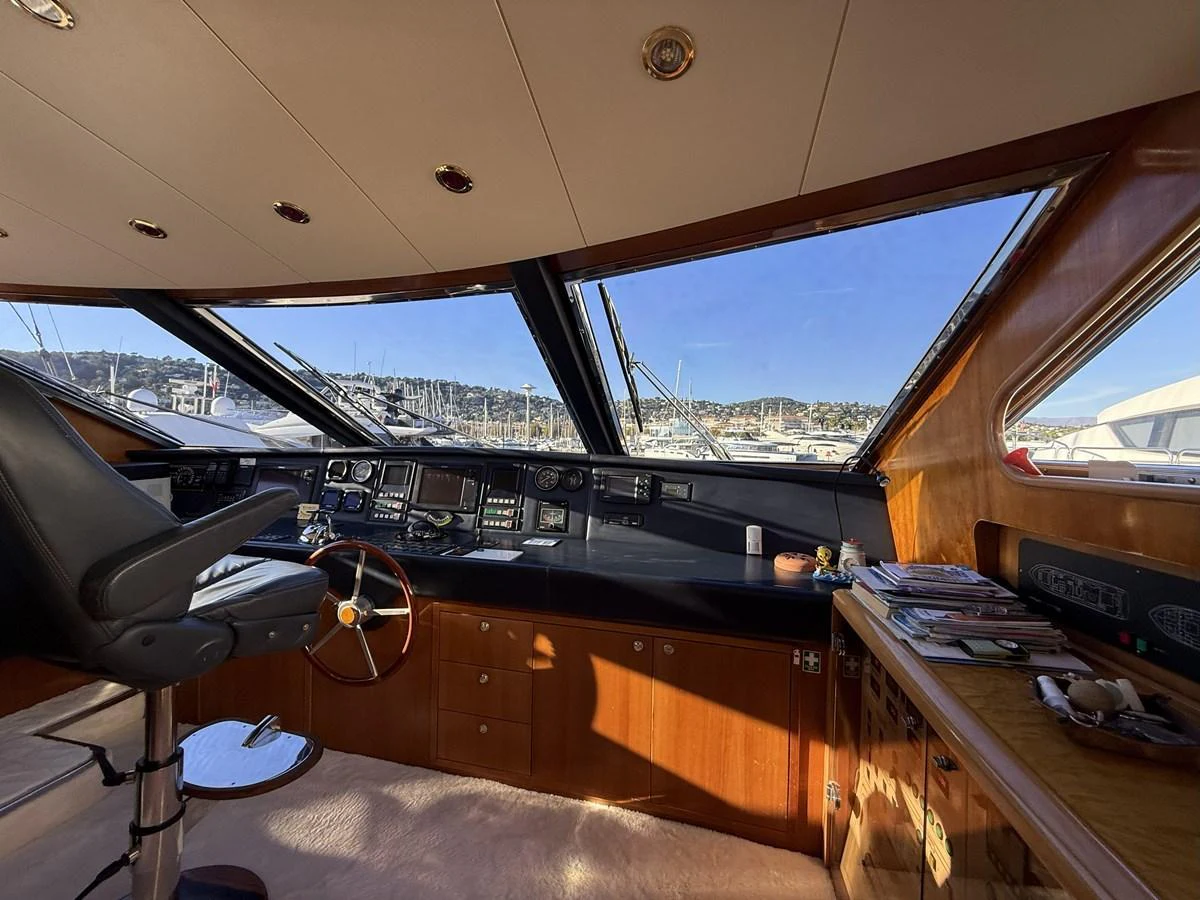 The helm station offers a commanding view with large windows and a well-equipped control panel. aboard SIKOY Yacht for Sale