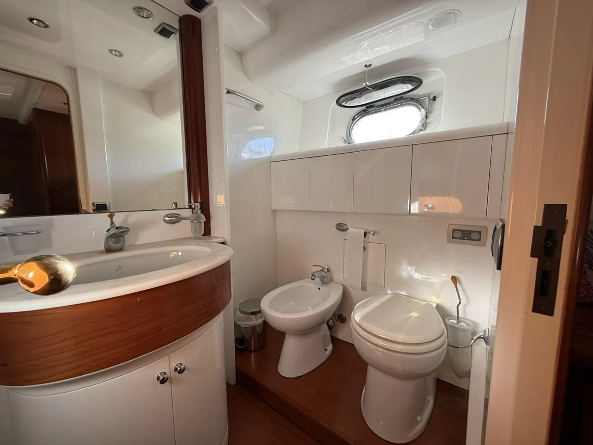 A well-appointed yacht bathroom featuring modern fixtures and elegant wood accents. aboard SIKOY Yacht for Sale