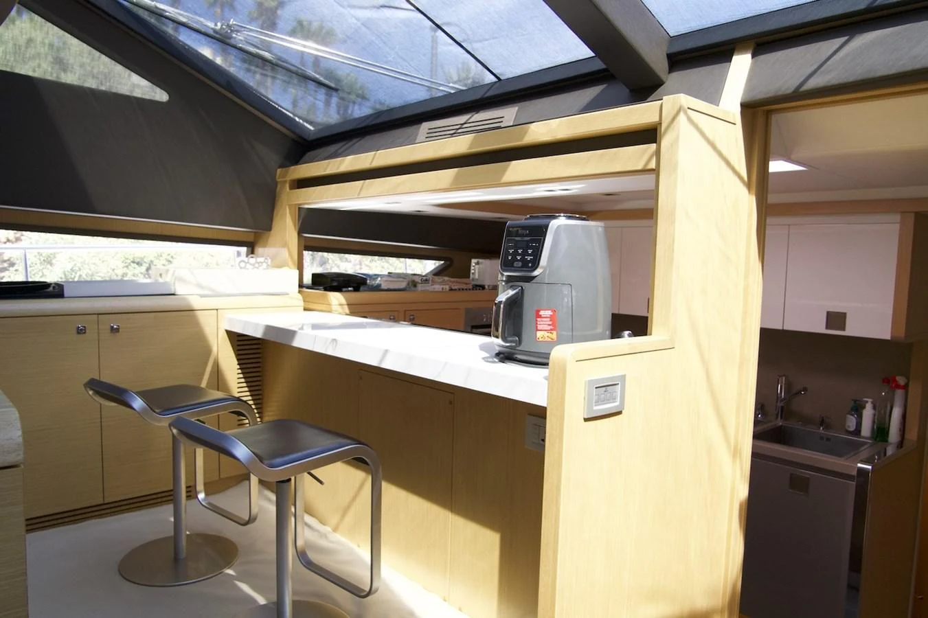 a kitchen with a microwave oven and a chair aboard ANTONINA Yacht for Sale