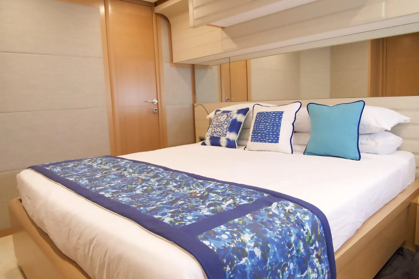 a bed with blue and white sheets aboard ANTONINA Yacht for Sale