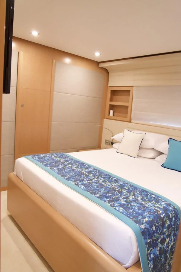a bed with blue sheets aboard ANTONINA Yacht for Sale