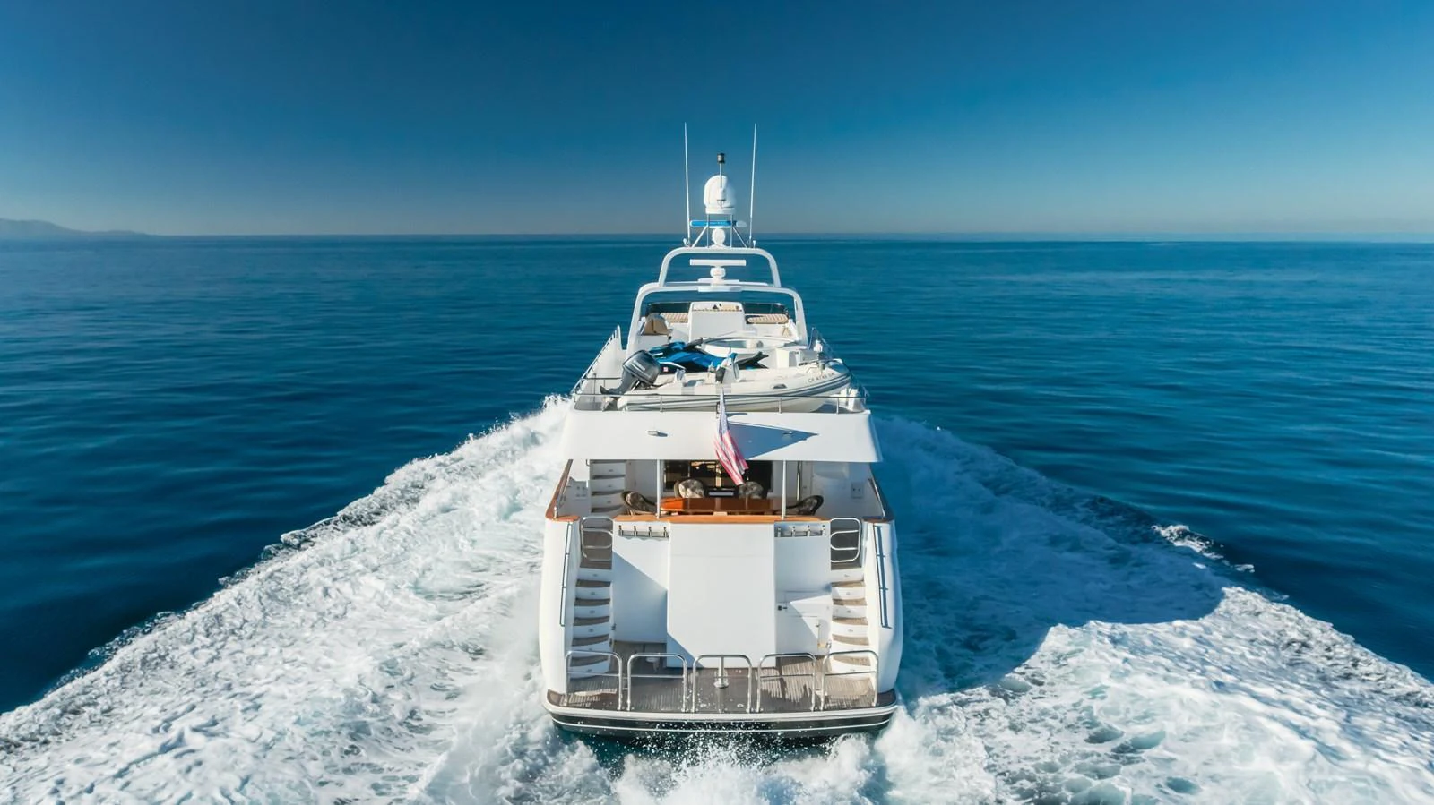 A luxurious yacht cruising on calm waters, showcasing its sleek design and spacious deck. aboard MONEY CAT Yacht for Sale