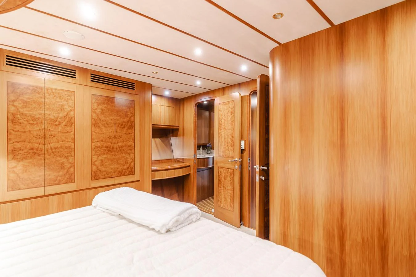 The stateroom features warm wood paneling and a cozy, inviting atmosphere. aboard MONEY CAT Yacht for Sale
