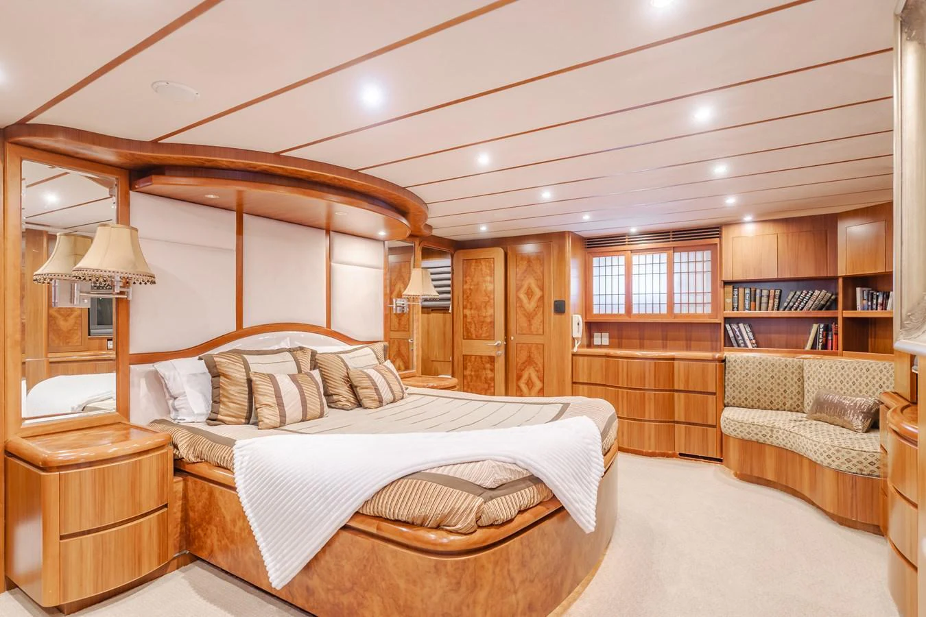 The master stateroom features a spacious bed, elegant wood finishes, and ample storage. aboard MONEY CAT Yacht for Sale