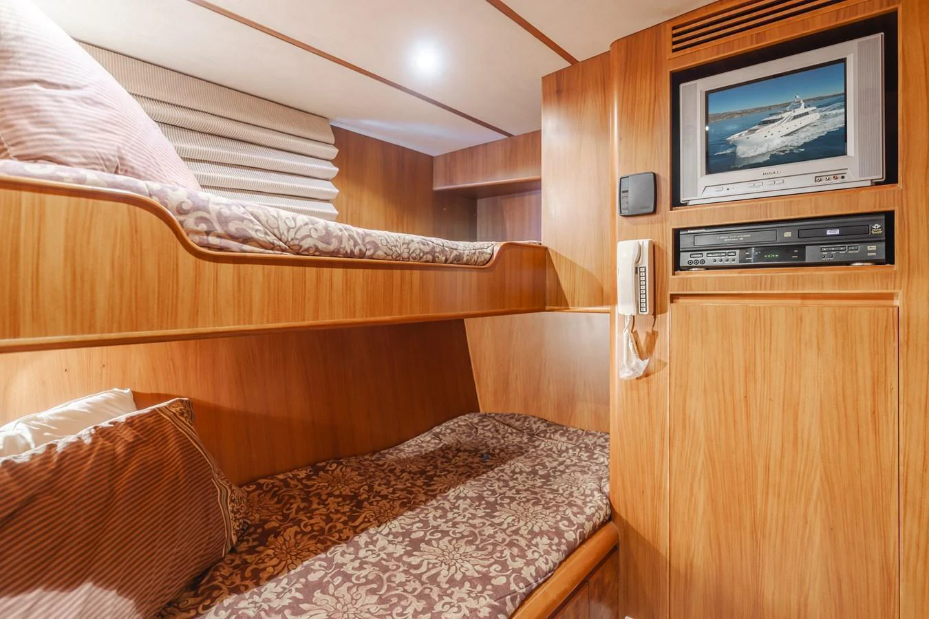 The cozy crew quarters feature bunk beds and a small entertainment system for comfort and relaxation. aboard MONEY CAT Yacht for Sale