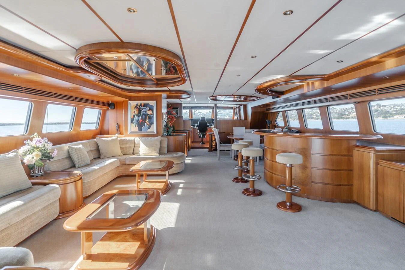 The spacious salon features elegant wood finishes, ample seating, and large windows offering stunning views. aboard MONEY CAT Yacht for Sale