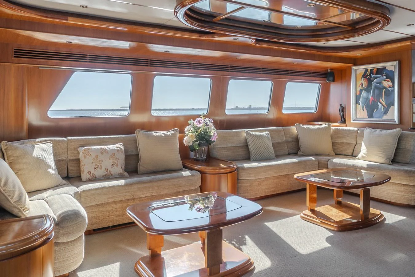 The salon features plush seating, large windows, and elegant wooden accents, creating a luxurious and inviting atmosphere. aboard MONEY CAT Yacht for Sale