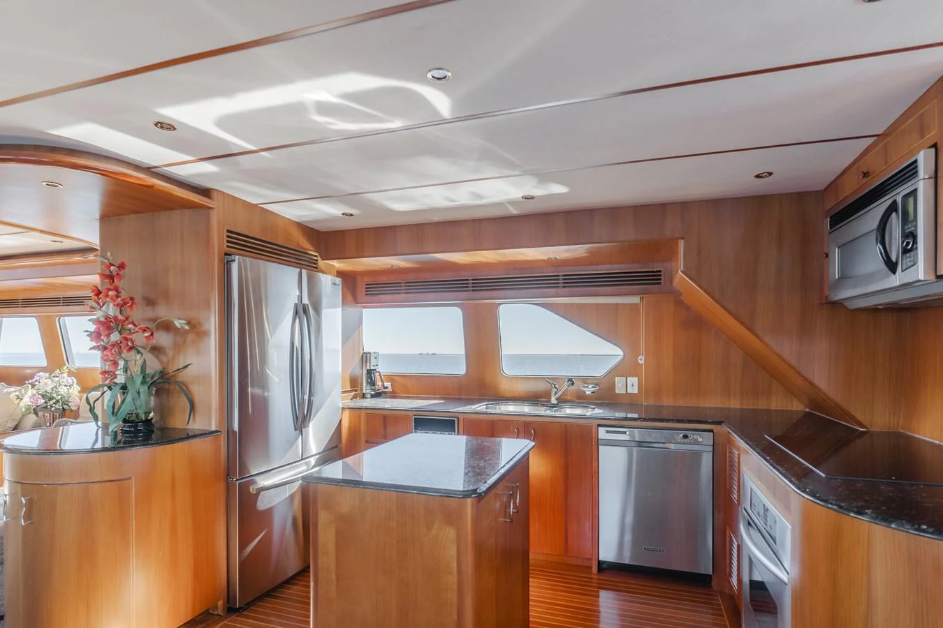 The galley features modern appliances and ample counter space with a warm wooden finish. aboard MONEY CAT Yacht for Sale