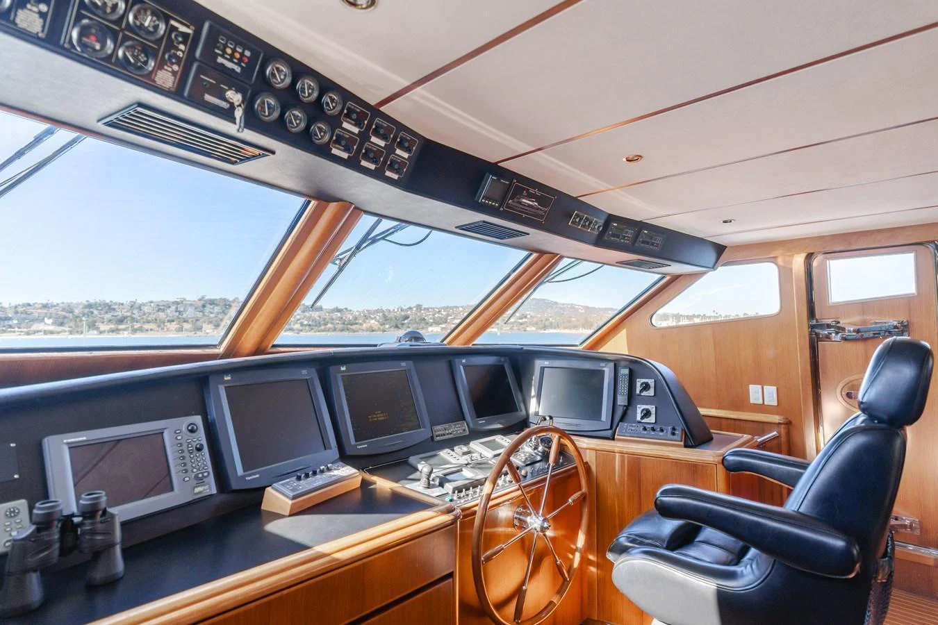 The helm station features advanced navigation equipment and a comfortable captain's chair, offering a commanding view of the surroundings. aboard MONEY CAT Yacht for Sale
