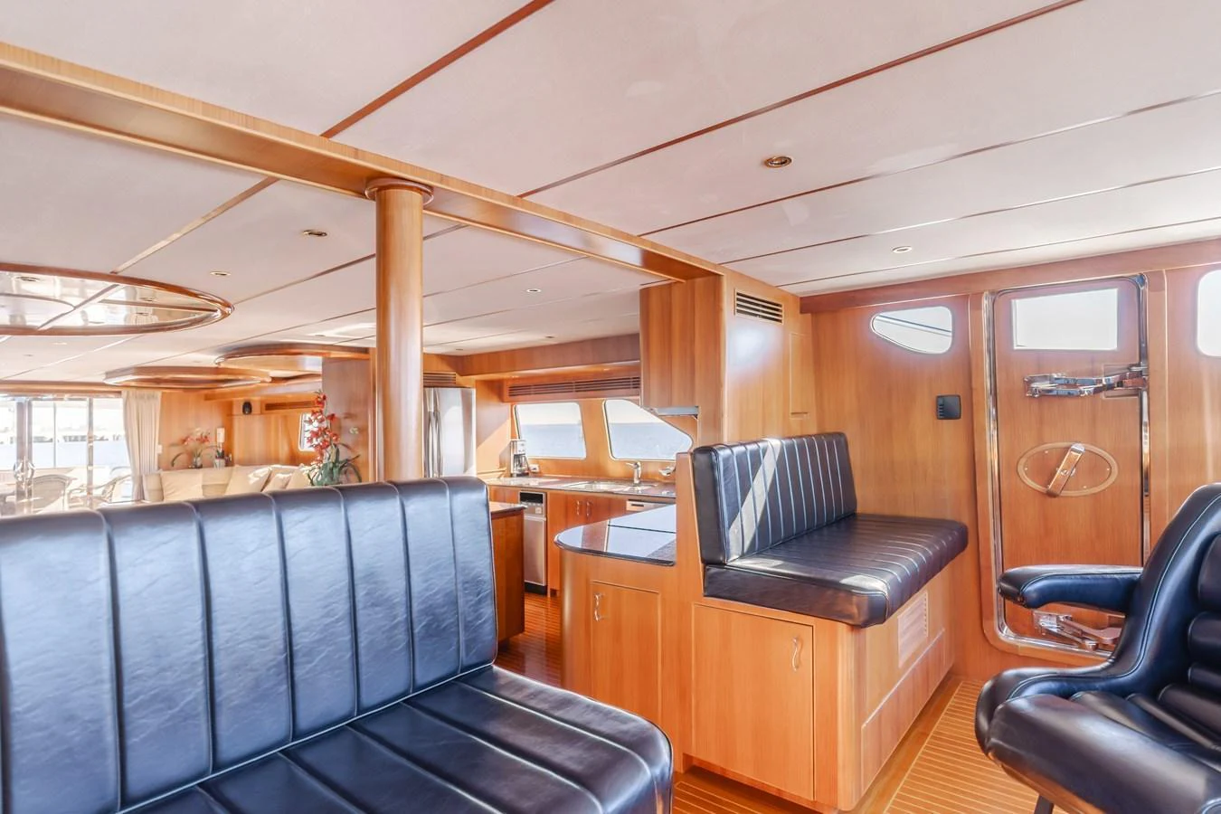 The yacht's salon features comfortable seating and a well-lit, spacious layout with wooden accents. aboard MONEY CAT Yacht for Sale