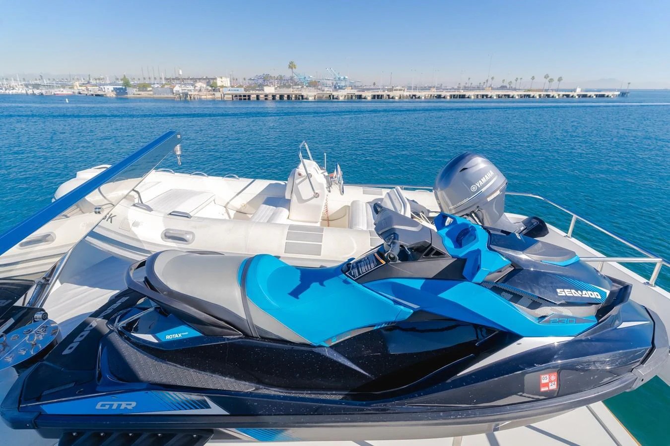 A sleek jet ski is positioned on the deck of a yacht, ready for thrilling water adventures. aboard MONEY CAT Yacht for Sale