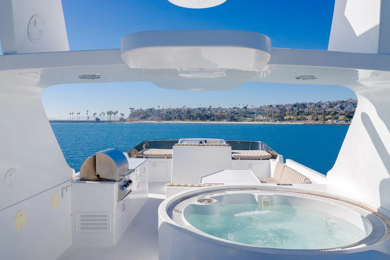 The sundeck features a luxurious hot tub and a barbecue grill with stunning ocean views. aboard MONEY CAT Yacht for Sale