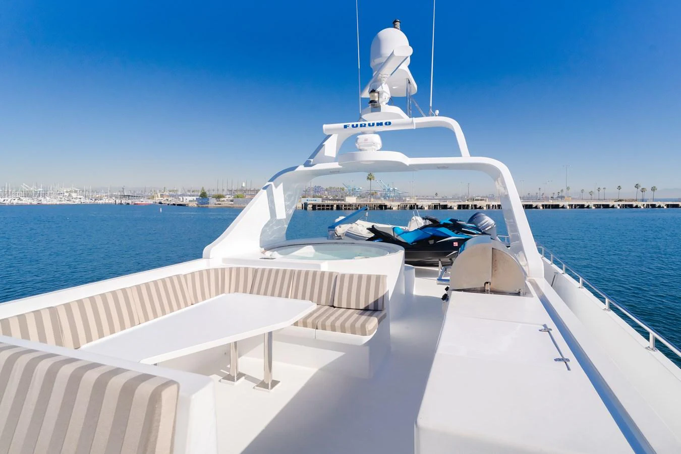 The flybridge offers a spacious seating area with a table, perfect for enjoying the view while cruising. aboard MONEY CAT Yacht for Sale