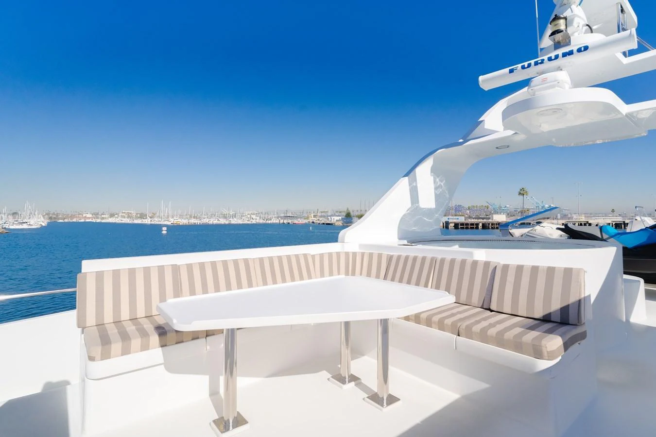 The flybridge offers a spacious seating area with a modern table, perfect for enjoying panoramic views. aboard MONEY CAT Yacht for Sale