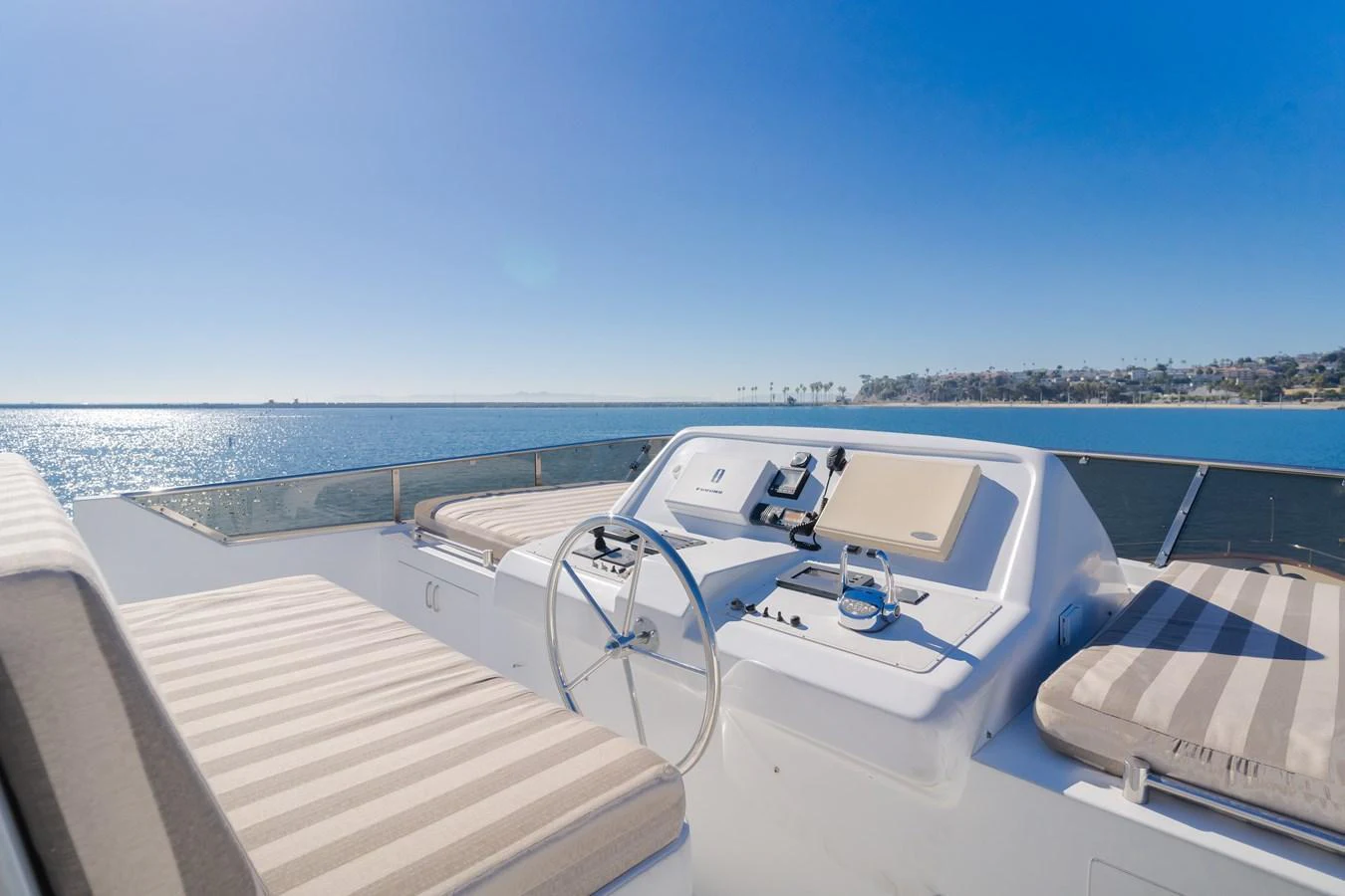 The yacht's helm offers a stunning view of the open sea, complemented by comfortable seating and modern controls. aboard MONEY CAT Yacht for Sale