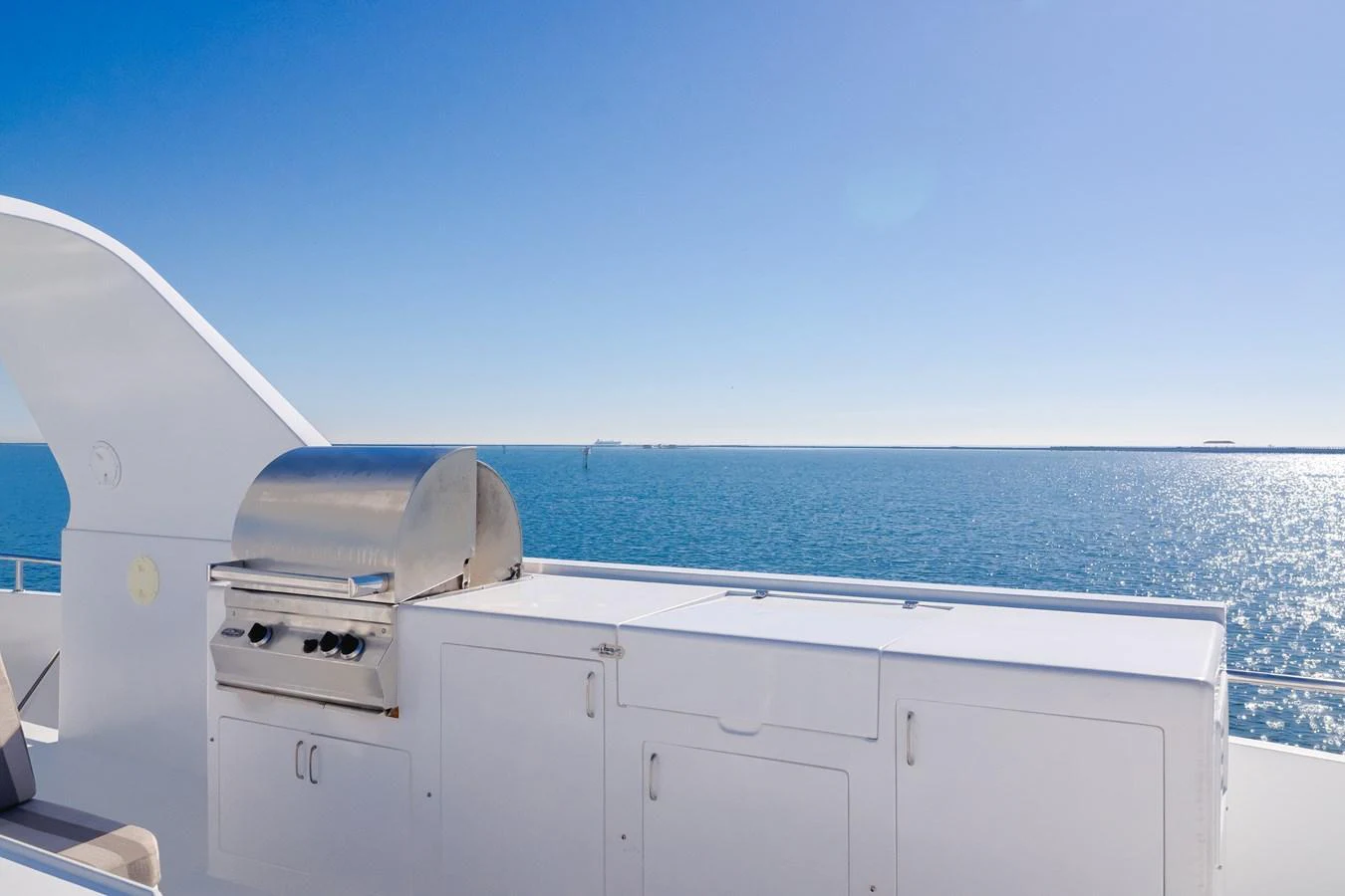 The sundeck features a built-in stainless steel grill with a stunning ocean view. aboard MONEY CAT Yacht for Sale
