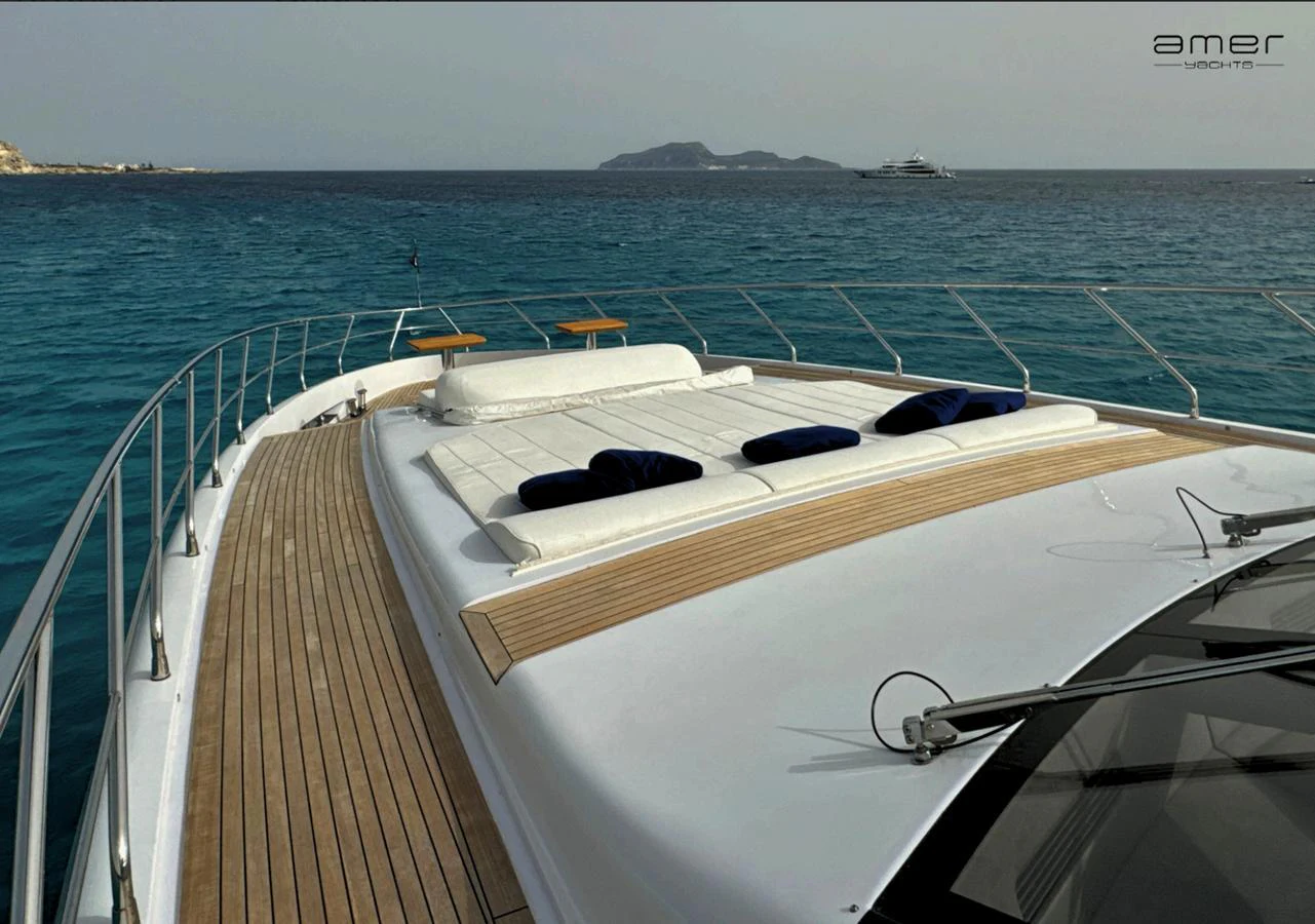 The yacht's foredeck offers a spacious sunbathing area with plush cushions, perfect for relaxation while cruising. aboard ALTUS Yacht for Sale
