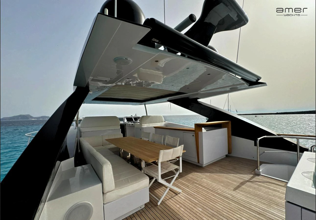 The flybridge offers a spacious and stylish outdoor dining area with panoramic sea views. aboard ALTUS Yacht for Sale