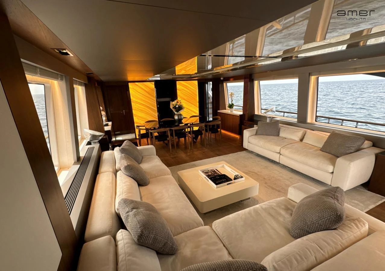 The salon offers a spacious and luxurious seating area with panoramic ocean views. aboard ALTUS Yacht for Sale