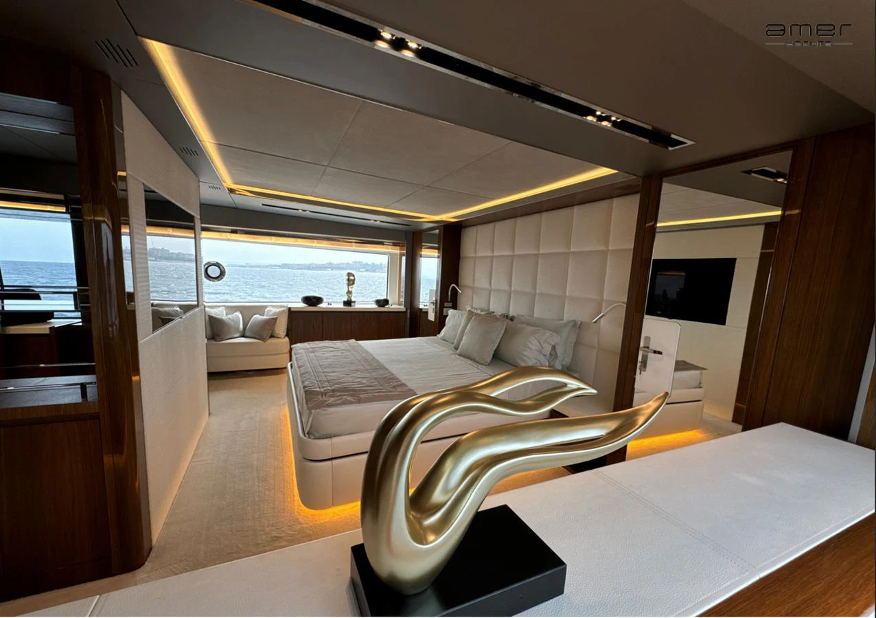 The master stateroom features a luxurious bed with elegant decor and a stunning view of the sea. aboard ALTUS Yacht for Sale
