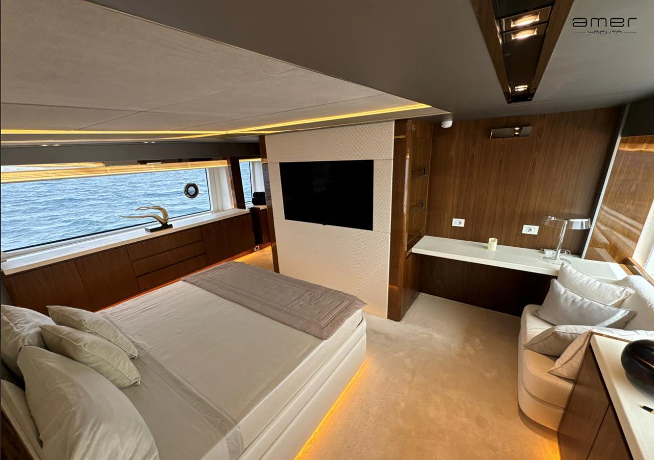 The master stateroom features a spacious bed, modern decor, and large windows offering a stunning view of the sea. aboard ALTUS Yacht for Sale