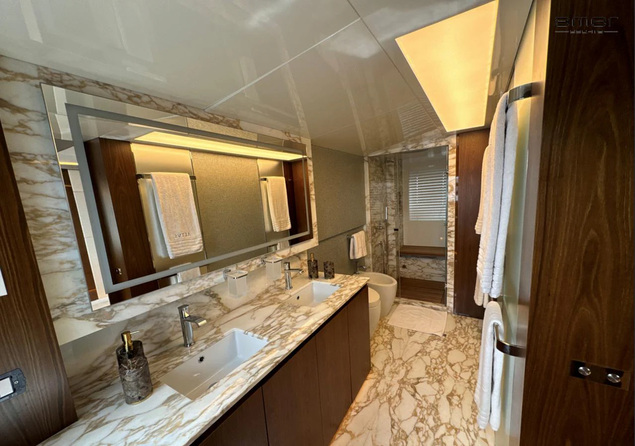 The yacht's bathroom features luxurious marble countertops and modern fixtures. aboard ALTUS Yacht for Sale